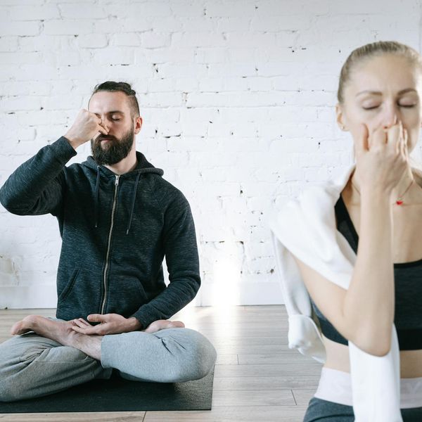 Person meditating peacefully in a brightly lit room.